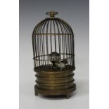 A 20th century brass novelty singing bird automaton clock, within a wirework case on turned feet,