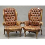 A pair of early/mid-20th century Queen Anne style buttoned red leather wing back armchairs with