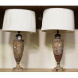 A pair of late 19th/early 20th century rouge marble table lamps, each carved in the form of a