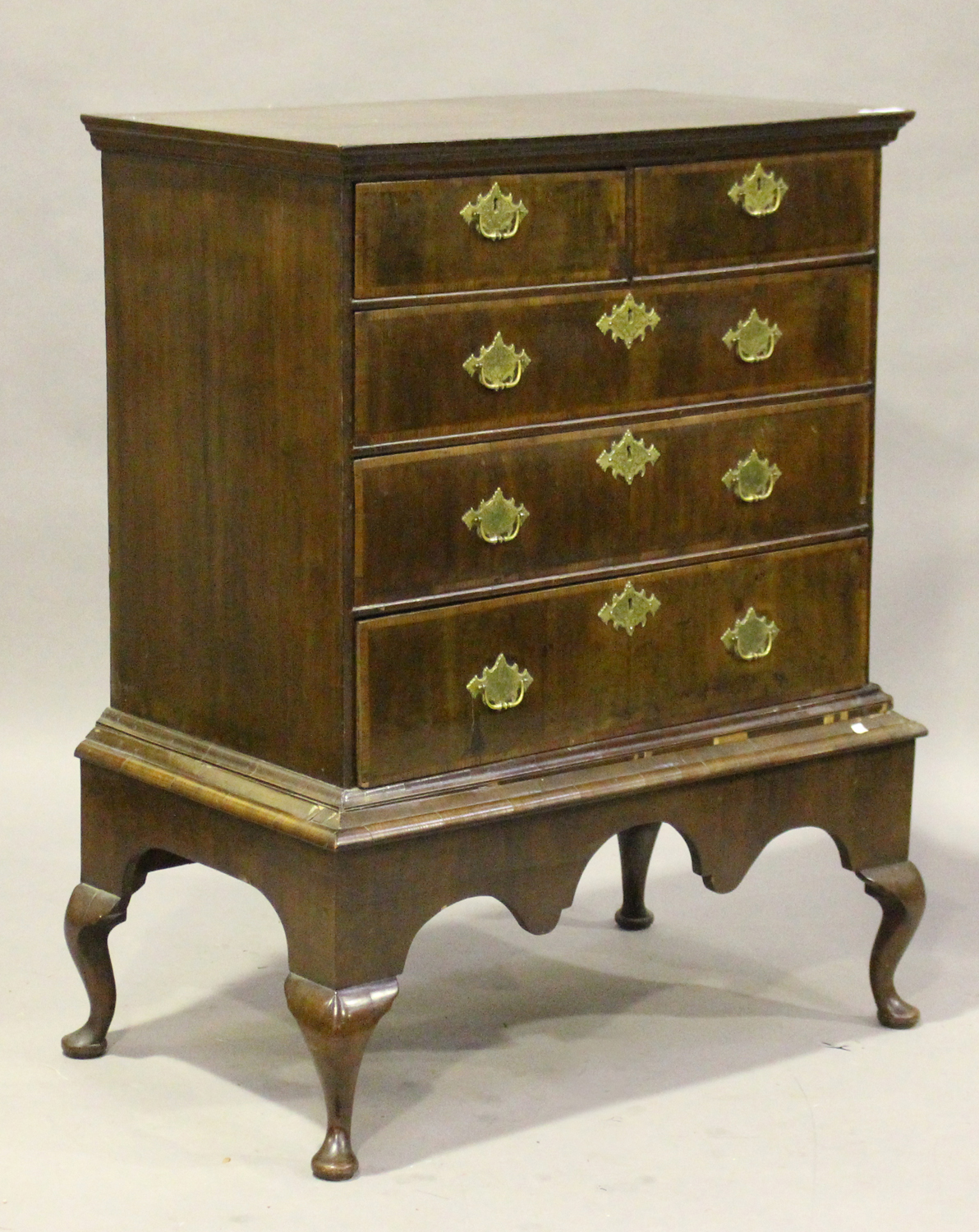 A George I and later walnut chest-on-stand, fitted with two short and three long drawers, the