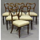 A set of six Victorian mahogany spoon back dining chairs, the overstuffed seats raised on turned and