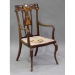 An Edwardian Art Nouveau mahogany elbow chair with pierced and inlaid decoration, on cabriole