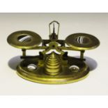 A set of mid-19th century gilt brass and banded agate postal scales, the two pans and oval base