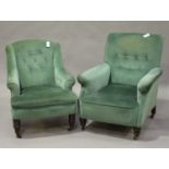 An Edwardian scroll armchair, upholstered in green velour, raised on ring turned legs and castors,