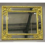 A 20th century rococo style giltwood framed rectangular wall mirror with scroll and stiff leaf