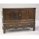 An 18th century oak mule chest, fitted with a pair of panelled doors above three drawers, on