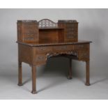 An Edwardian Chinese Chippendale style figured mahogany writing desk with overall pierced and