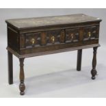 A 19th century Jacobean Revival oak dresser base, the two frieze drawers with applied geometric
