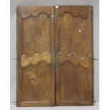 A pair of 19th century French armoire doors with wrought metal hinges, height 154cm, width 58cm.