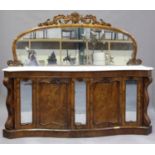 A Victorian walnut mirror back side cabinet with white marble top, the serpentine front fitted