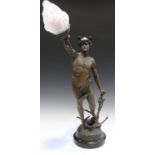 A late 19th century figural spelter table lamp in the form of Mercury holding a frosted glass