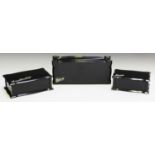 A set of three George V ebony and silver mounted dressing table boxes, the serpentine tops with