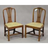 A set of six George III fruitwood pierced splat back dining chairs with drop-in seats, on block