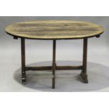 A late 18th/early 19th century French provincial walnut oval tip-top trestle table, on block