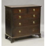 A George III mahogany chest of two short and three graduated long drawers, on splayed bracket