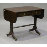 A 20th century Regency style mahogany sofa table, fitted with two frieze drawers, on sabre legs,