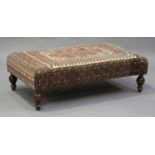 A modern rectangular footstool, upholstered in Turkish carpet, on turned feet, height 45cm, width