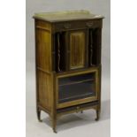 An Edwardian mahogany music cabinet by Edwards and Roberts, with blind fretwork decoration, the