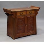 A late 20th century Chinese hardwood side cabinet with carved decoration, fitted with two drawers