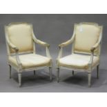 A pair of 20th century Louis XVI style grey painted fauteuil armchairs, the overstuffed seats and