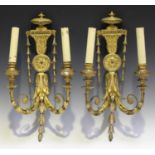 A pair of late Victorian Neoclassical Revival gilt composition twin-light wall sconces, each urn