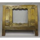 A 19th century French walnut headboard with central aperture, carved with overall leaf decoration