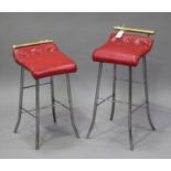 A pair of early 20th century polished steel and brass music chairs with red leatherette seats, on
