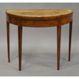 A George III figured mahogany demi-lune fold-over card table with crossbanded and inlaid decoration,