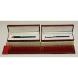 A Must de Cartier fountain pen and matching roller ball pen, both finished in malachite-effect and