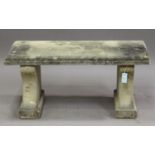 A 20th century cast composition stone garden bench, the rectangular top on a pair of shaped