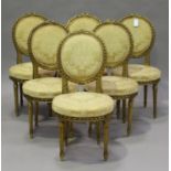 A set of six early 20th century Louis XVI style gilt painted chairs, the overstuffed seats and backs