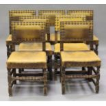 A group of fourteen early 20th century oak framed dining chairs, comprising two sets of six and