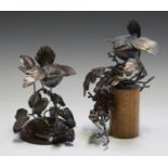 Gordon Griffiths - two patinated wrought metal models of birds perched on leafy branches, both bases
