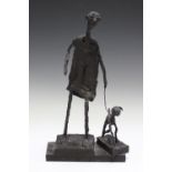 A modern bronze-effect fibreglass figure, in the manner of Alberto Giacometti, modelled as a