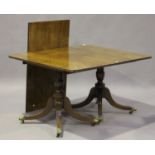 A George III mahogany rectangular dining table with single extra leaf, raised on turned columns