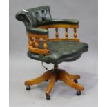 A 20th century reproduction mahogany and green leather tub back office chair with studwork