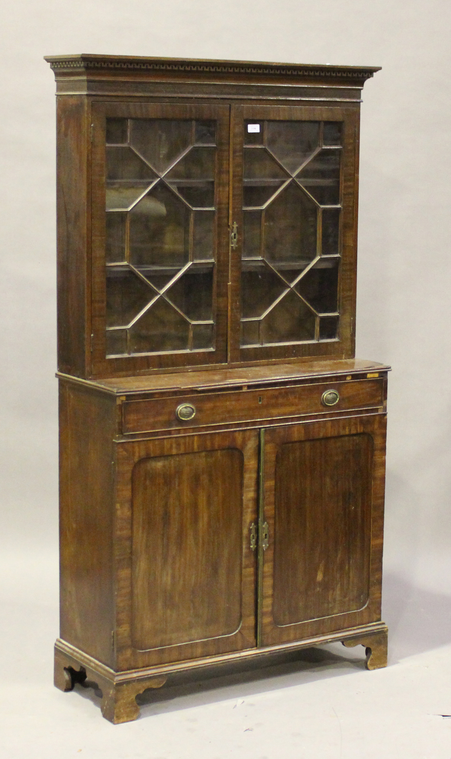 A 20th century George III style mahogany bookcase cabinet, fitted with a pair of astragal glazed