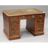 A mid-Victorian mahogany twin pedestal desk, the moulded top inset with gilt-tooled leather above an