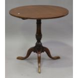 A 20th century George III style oak circular tip-top wine table, the turned column on tripod