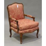 A late 20th century Louis XV style stained beech fauteuil armchair, the upholstered seat and back