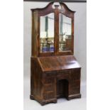A late 18th century rosewood bureau bookcase with shaped sides, the swan neck pediment above a