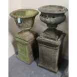 Two 20th century cast composition stone garden urns, both raised on square pedestals, heights