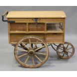 An early 20th century and later French street vendor's cart with domed hinged lid and three metal