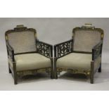 A George V ebonized and chinoiserie decorated three-piece bergère suite, the cane backs above