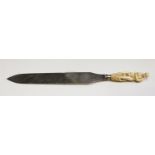 A 17th century and later ivory handled knife, the handle carved in the form of a lady on the