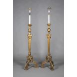 A pair of early 20th century Neoclassical Revival giltwood lamp-standards, each decorated with