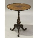 An early Victorian mahogany circular wine table, raised on a twisted column and tripod scroll