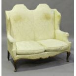 A 20th century Queen Anne style two-seat sofa with double-arched back, on cabriole legs, height