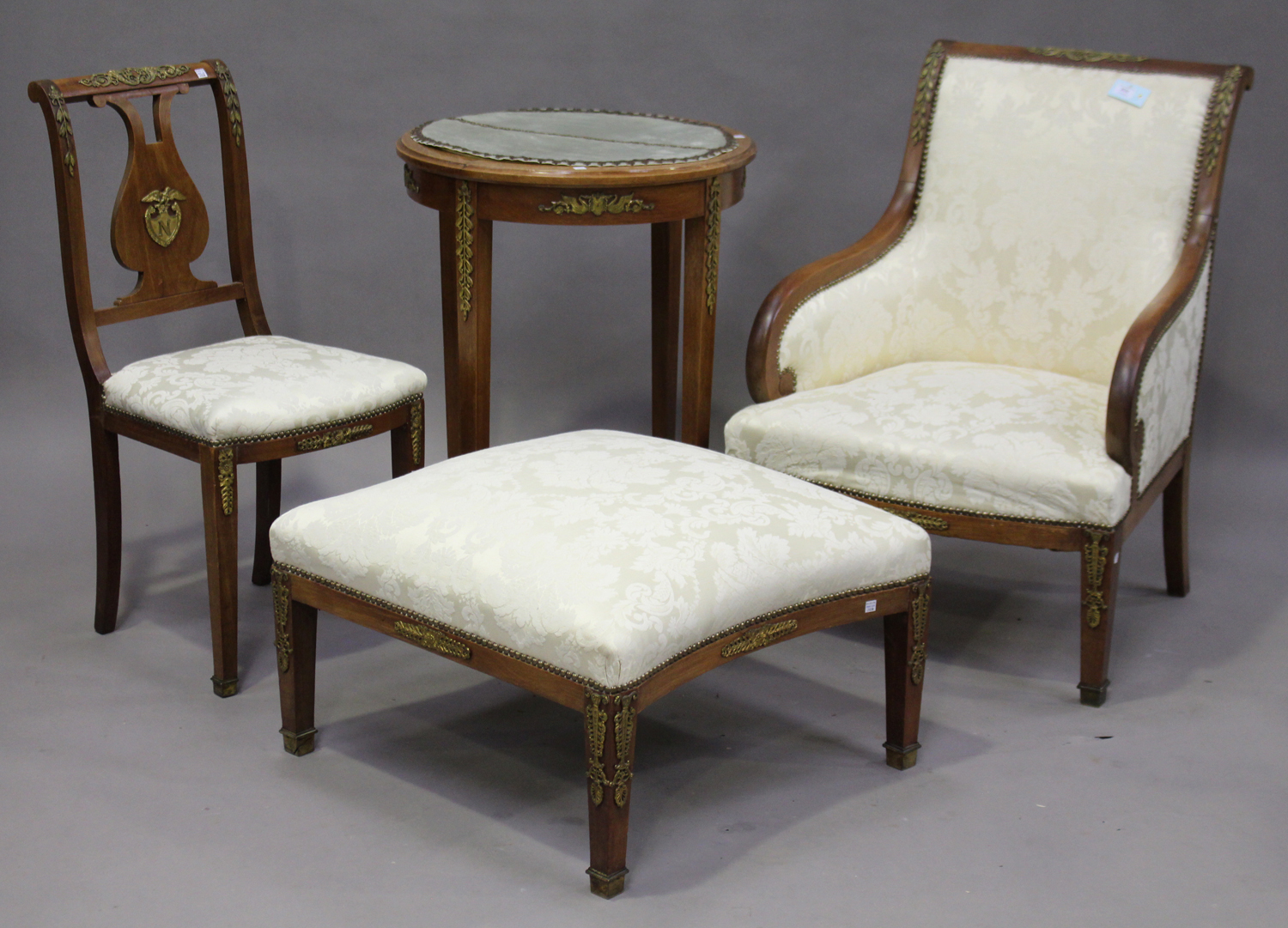 A suite of 20th century Empire style mahogany furniture, all with gilt metal Napoleonic crests and