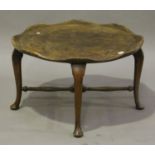 An early 20th century provincial style elm and stained beech occasional table, the slightly dished